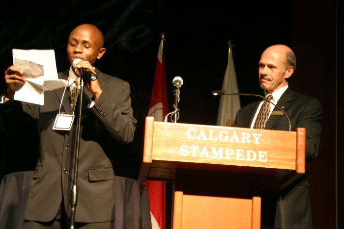 Ryan Perez reading his notes at the Calgary Stampede podium